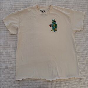 Riot Society Cream Tee with Green Bear Design